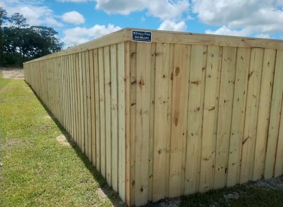 1781787925447_Screenshot-2026-06-18-at-9.05.04a-AM Man installing wooden picket fence outdoors