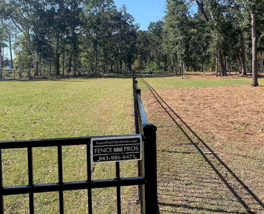 1781875627751_Screenshot-2026-06-19-at-9.26.49a-AM Homeowner consulting local fence installer outdoors
