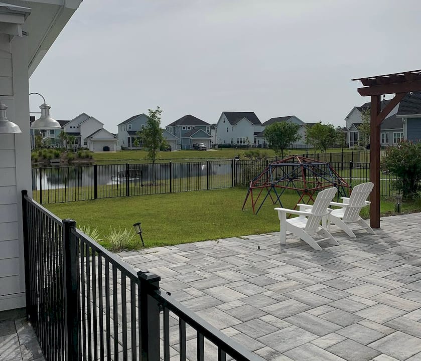 1782222946284_Screenshot-2026-06-23-at-9.55.30a-AM Modern home with ornamental aluminum fence in yard