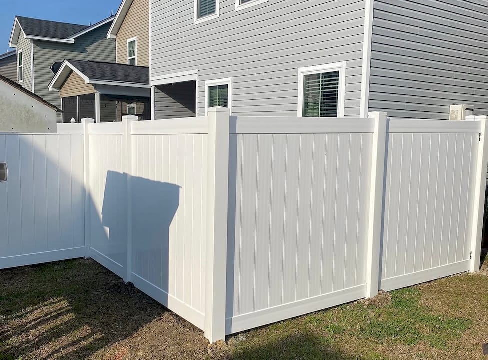 1782311853324_IMG_1328 Homeowner inspecting vinyl fence in backyard